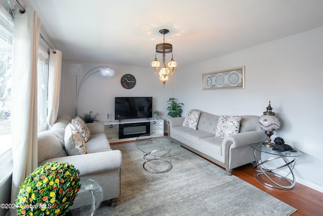 living room featuring a notable chandelier and dark hardwood / wood-style floors