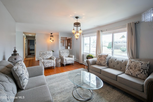 living room with light hardwood / wood-style floors and an inviting chandelier