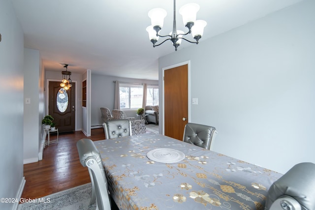 dining room with dark hardwood / wood-style floors, a baseboard heating unit, and an inviting chandelier