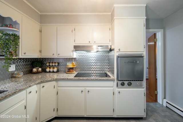 kitchen featuring wall oven, a baseboard heating unit, backsplash, black electric cooktop, and white cabinets