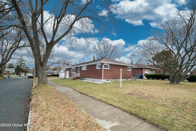 view of side of property with a lawn