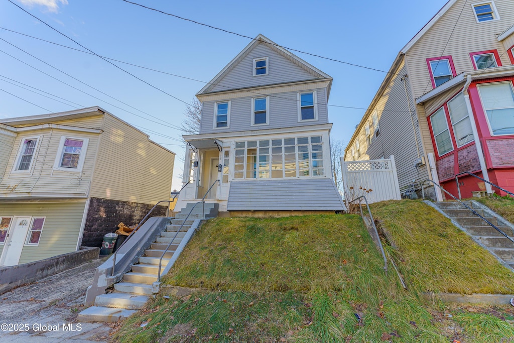 view of property featuring a front lawn