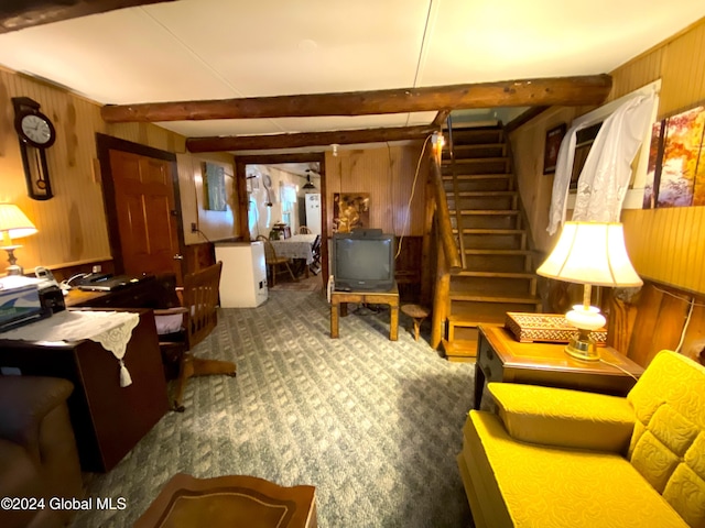 interior space featuring beam ceiling, wood walls, and carpet flooring