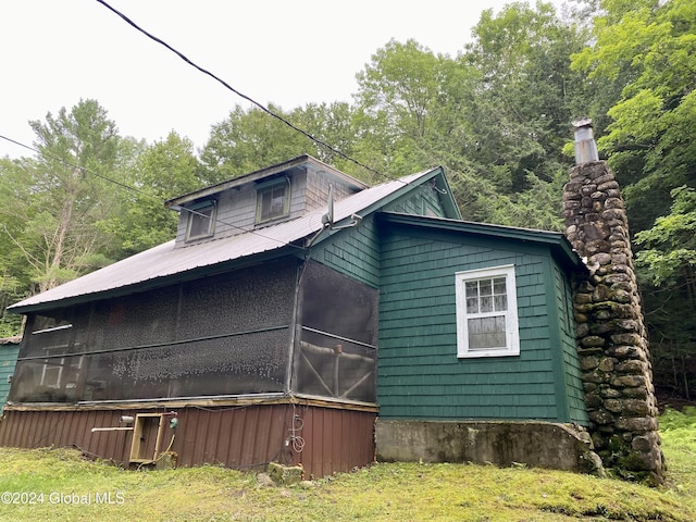 view of side of home with a sunroom