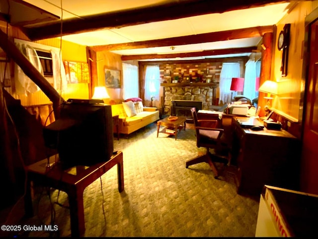 living area with a fireplace, beam ceiling, and carpet flooring