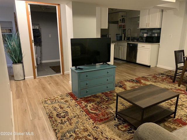 living room featuring sink and light wood-type flooring