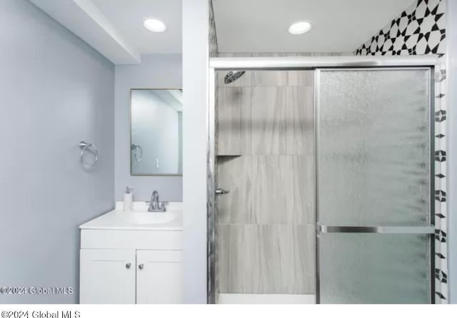 bathroom with vanity and an enclosed shower