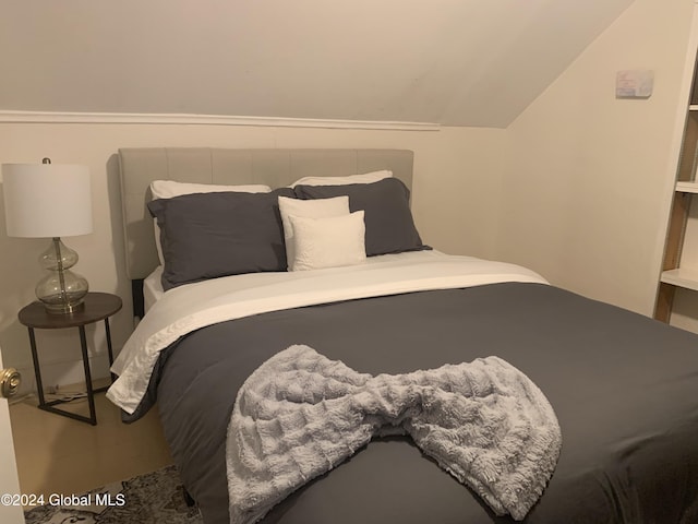 bedroom with lofted ceiling