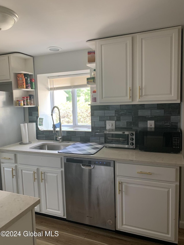 kitchen featuring sink, dark wood-type flooring, dishwasher, white cabinetry, and decorative backsplash