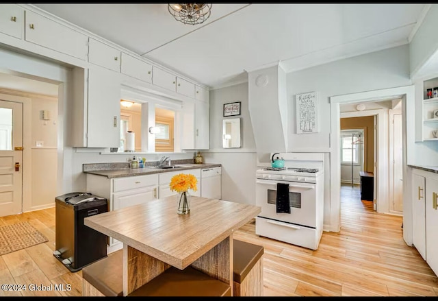 kitchen featuring ornamental molding, sink, white cabinets, and white appliances