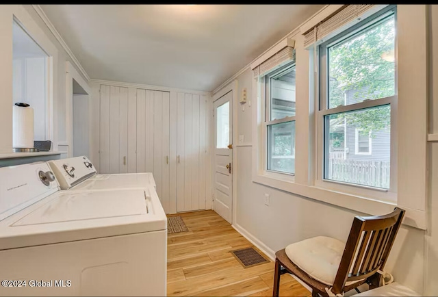 washroom with washer and dryer and light wood-type flooring