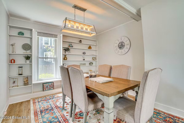 dining room featuring ornamental molding and light hardwood / wood-style floors