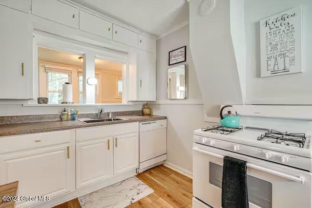 kitchen with sink, white appliances, ornamental molding, and white cabinets