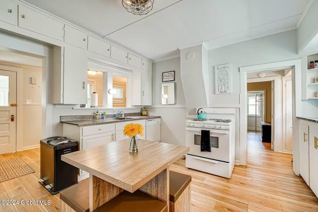 kitchen with sink, white appliances, white cabinetry, ornamental molding, and light hardwood / wood-style floors