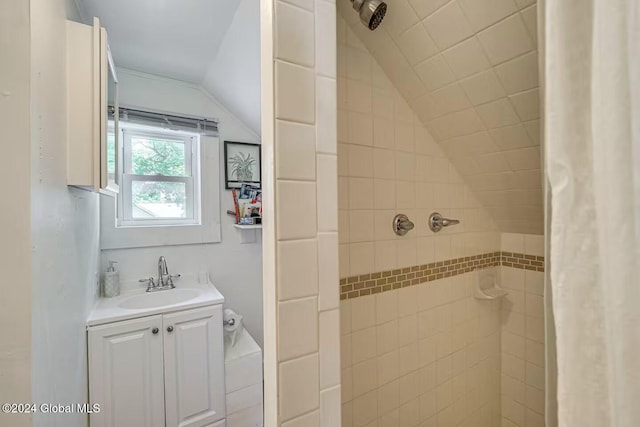 bathroom featuring vanity, vaulted ceiling, and a shower with shower curtain