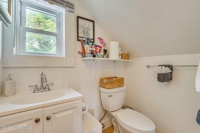 bathroom featuring lofted ceiling, vanity, and toilet