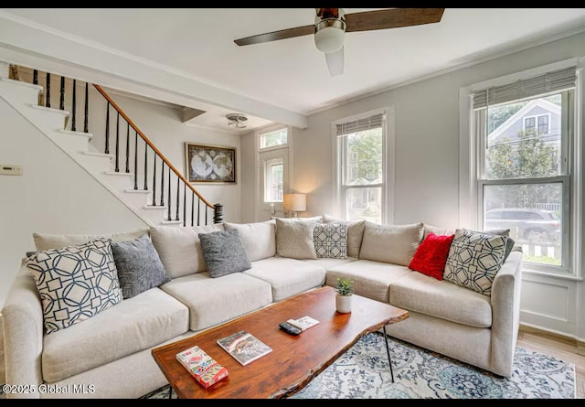 living room featuring crown molding, plenty of natural light, ceiling fan, and light hardwood / wood-style floors