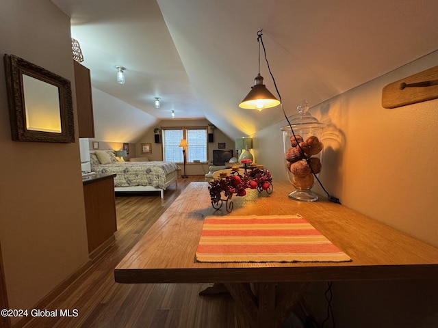 bedroom with wood-type flooring and lofted ceiling