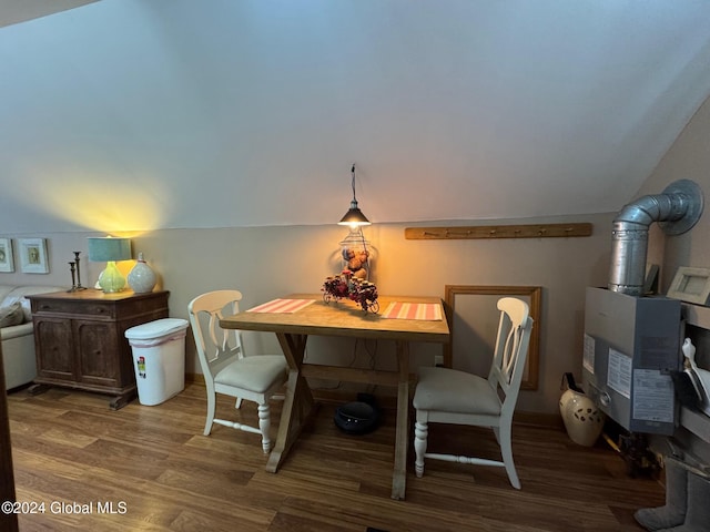 dining room with wood-type flooring and lofted ceiling