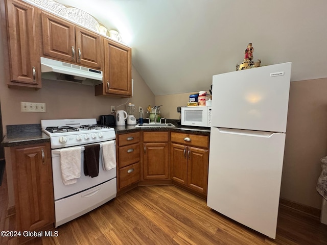 kitchen featuring light wood-type flooring, white appliances, sink, and vaulted ceiling