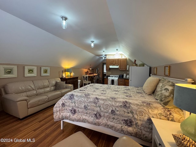 bedroom with dark wood-type flooring, white fridge, and lofted ceiling