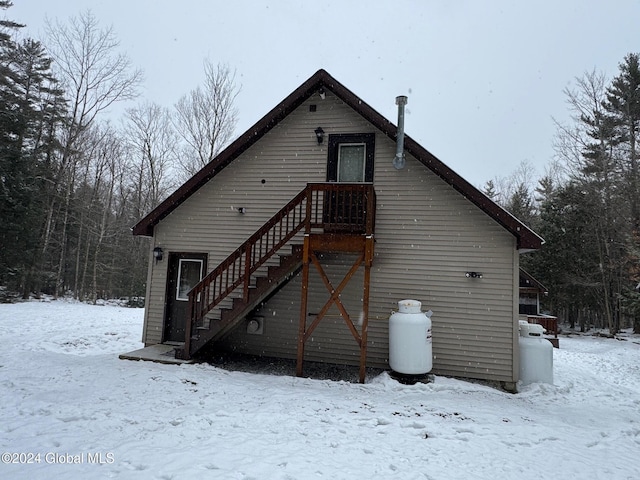 view of snow covered back of property