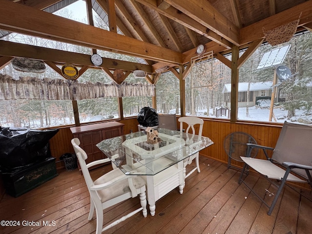 sunroom / solarium featuring lofted ceiling with beams and a wealth of natural light