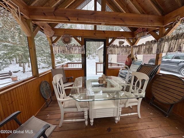 sunroom with vaulted ceiling with beams