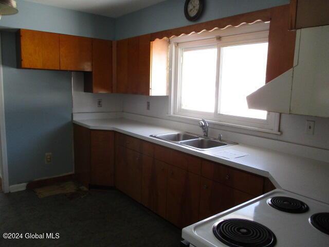 kitchen with white range oven and sink