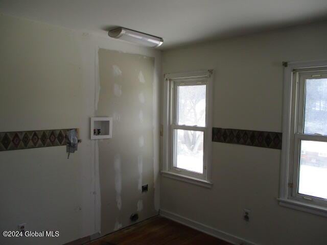 laundry room with washer hookup, dark hardwood / wood-style floors, and a wealth of natural light