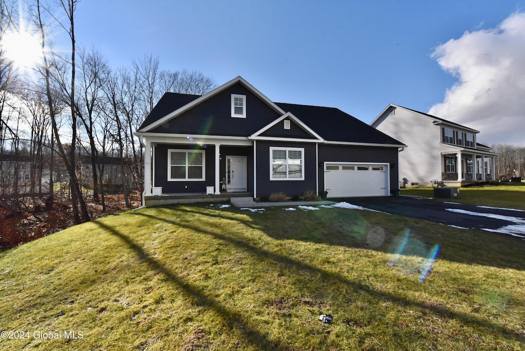 view of front of property with a front lawn and a garage