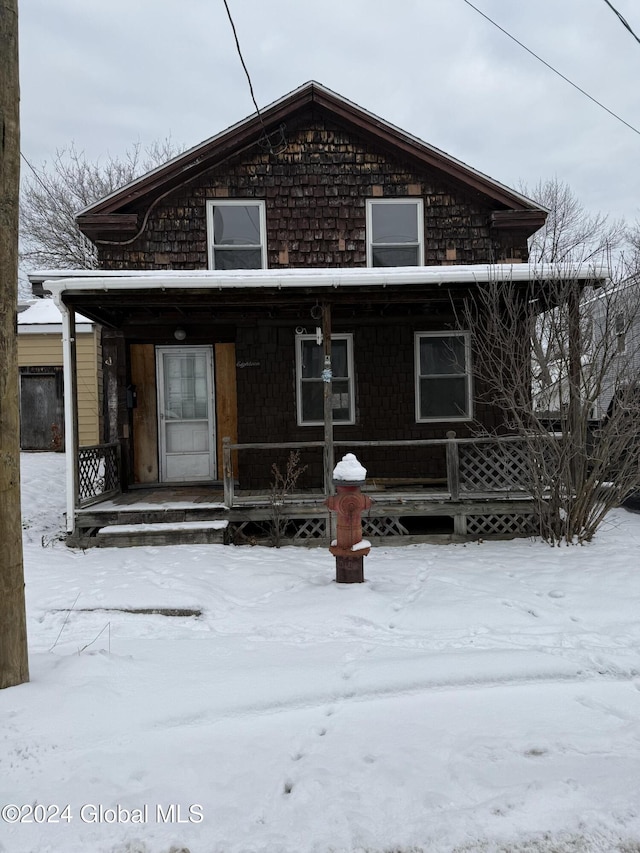 snow covered house with a porch