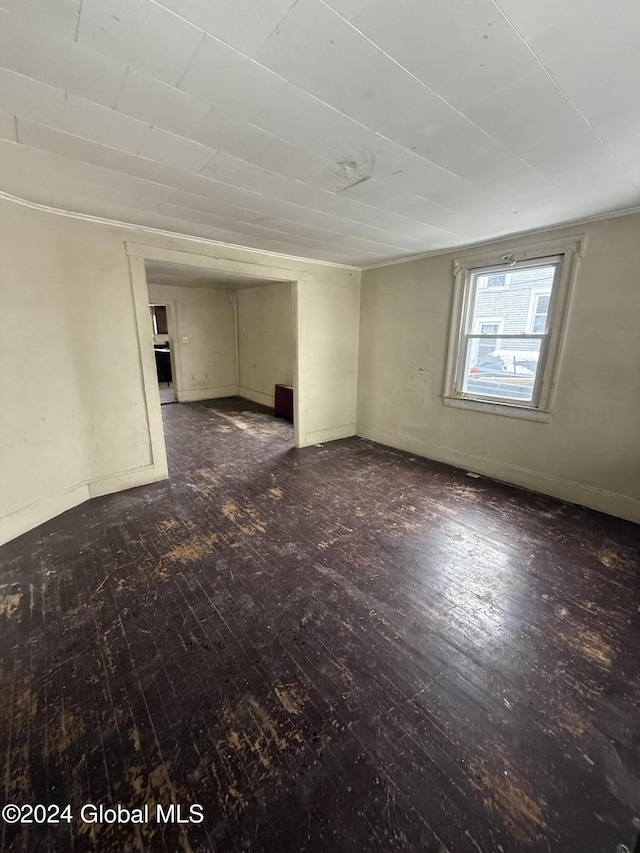 unfurnished room with dark wood-type flooring