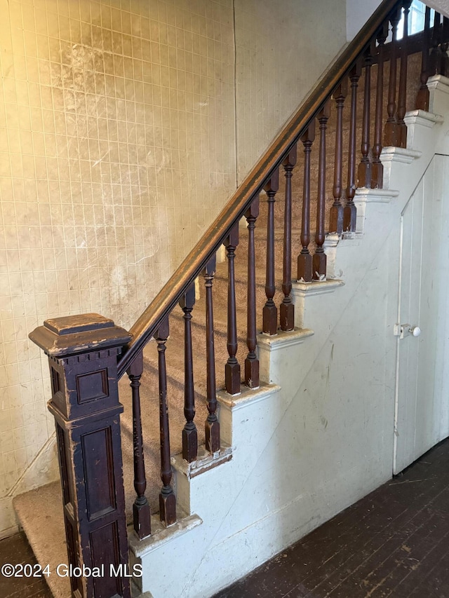 stairs with wood-type flooring