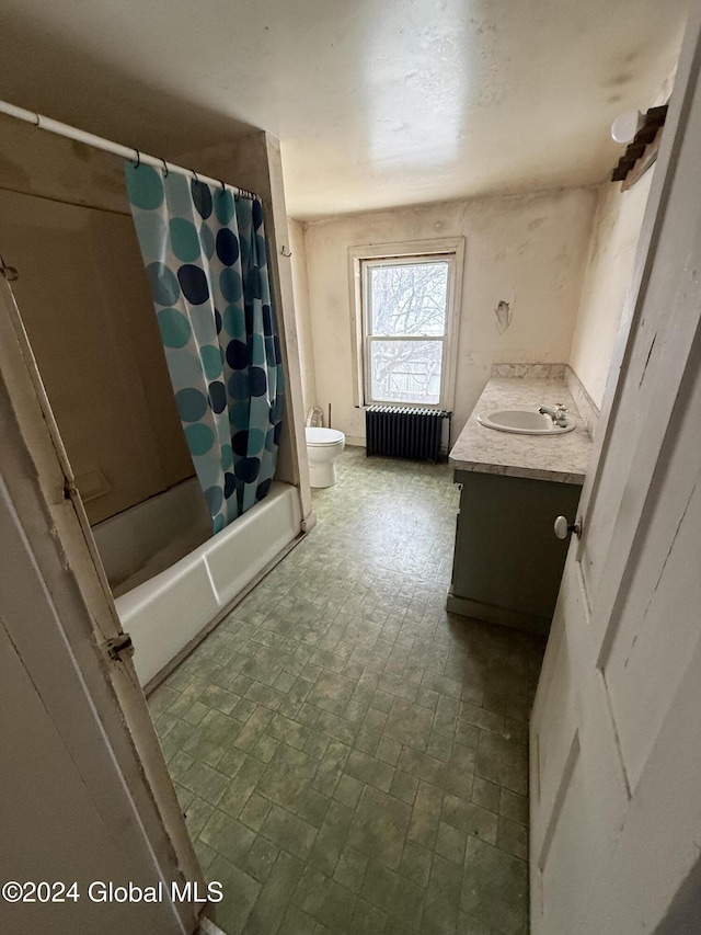 full bathroom with toilet, radiator heating unit, vanity, and shower / tub combo with curtain