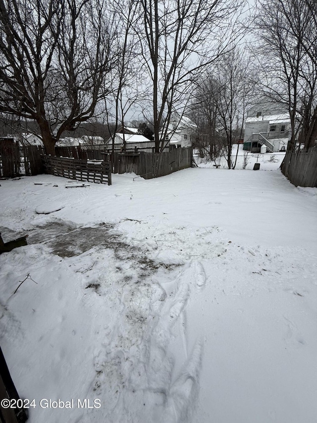 view of yard layered in snow