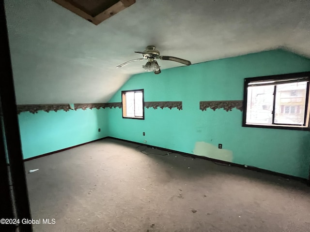 additional living space with vaulted ceiling and ceiling fan