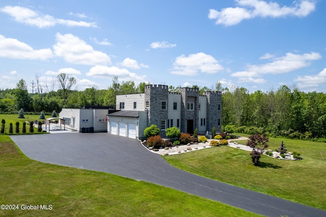 view of front of house with a garage and a front lawn