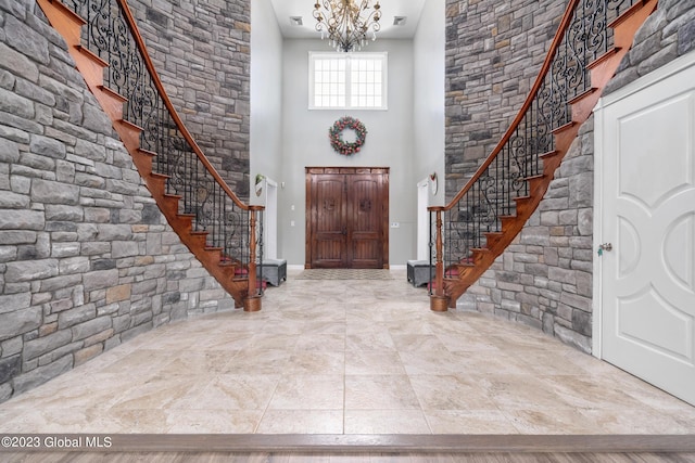 entryway featuring a notable chandelier and a high ceiling