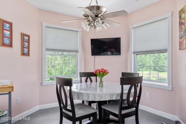 tiled dining room featuring ceiling fan