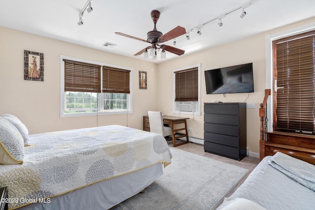 bedroom featuring ceiling fan, cooling unit, and rail lighting