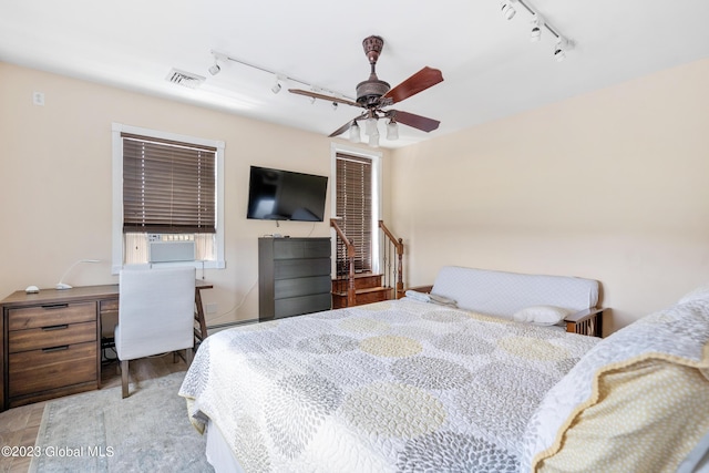 bedroom featuring ceiling fan, cooling unit, and track lighting