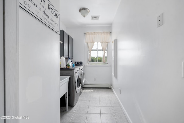 laundry room with cabinets, light tile patterned floors, washer and dryer, and a baseboard radiator