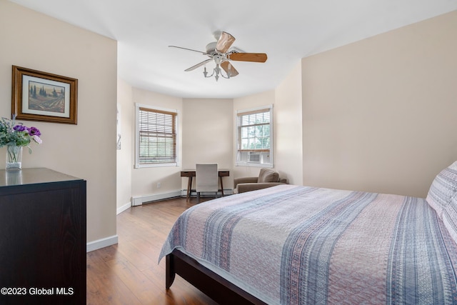 bedroom with wood-type flooring, baseboard heating, and ceiling fan