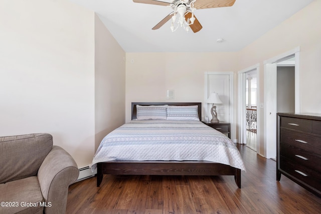 bedroom featuring hardwood / wood-style flooring, ceiling fan, and baseboard heating