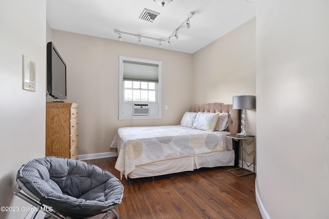 bedroom featuring cooling unit and dark wood-type flooring