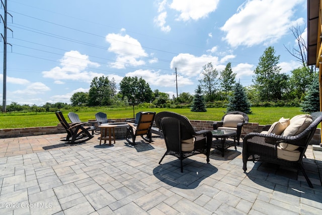 view of patio / terrace featuring an outdoor living space with a fire pit