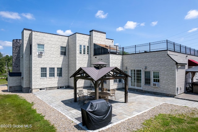 rear view of property with a gazebo and a patio area