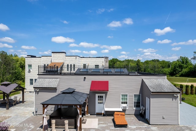 view of front of house with a gazebo, a patio area, and cooling unit