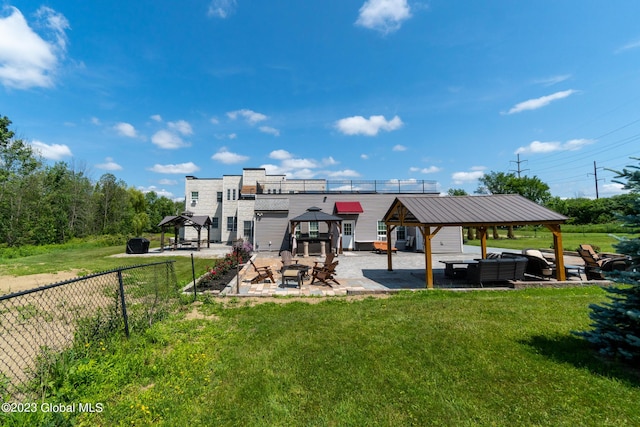 exterior space featuring a gazebo, an outdoor hangout area, a patio area, and a lawn